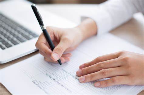 A woman completing an application form.
